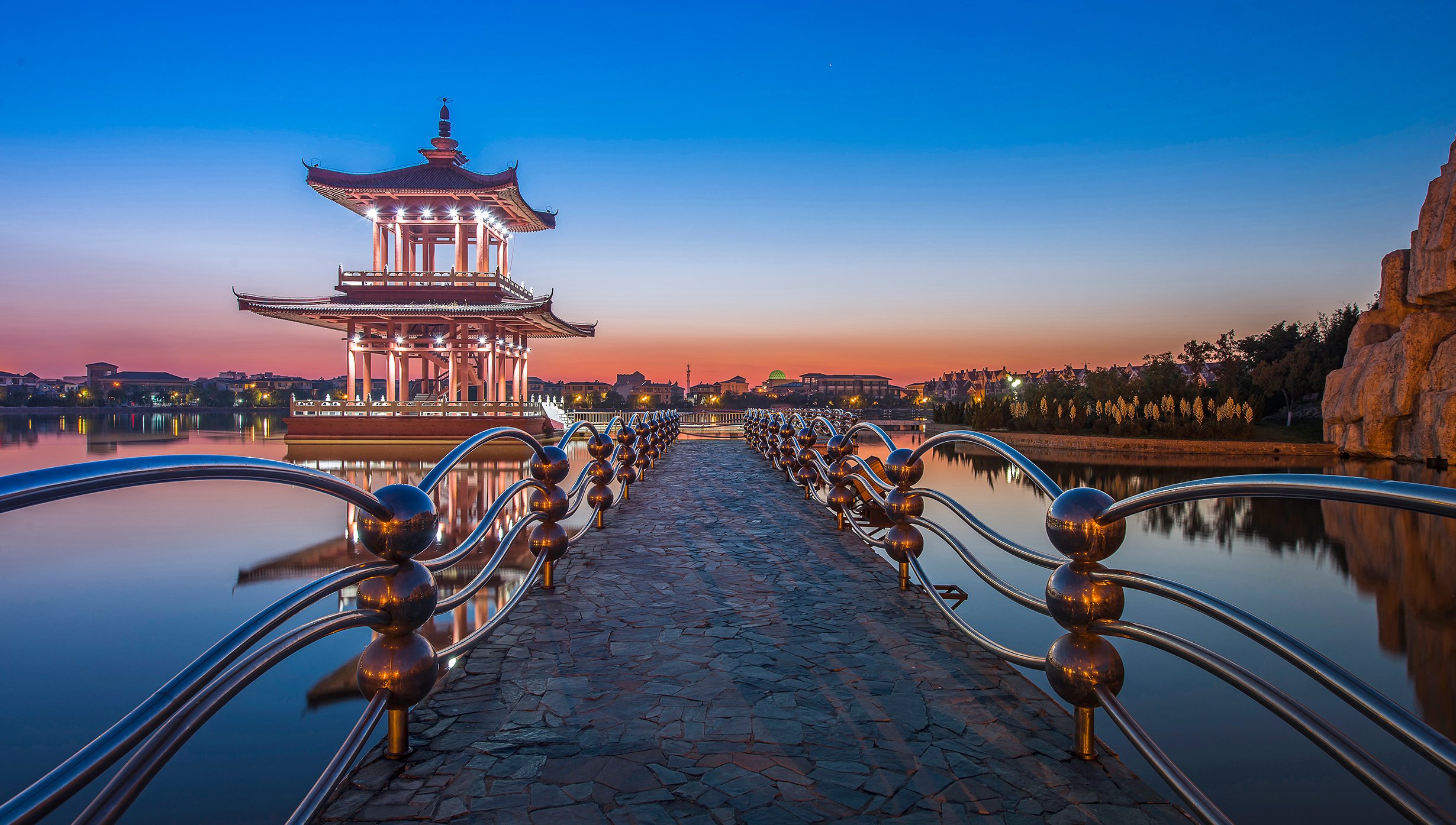 A traditional Chinese pavilion on a serene lake at sunset | MSC Cruises A traditional Chinese pavilion on a serene lake at sunset | MSC Cruises