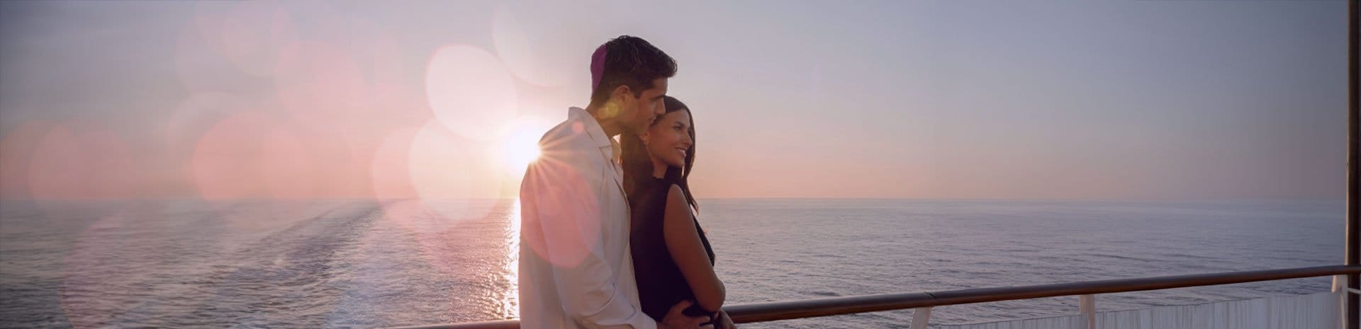 Couple on a ship at sunset | MSC Cruises Couple on a ship at sunset | MSC Cruises