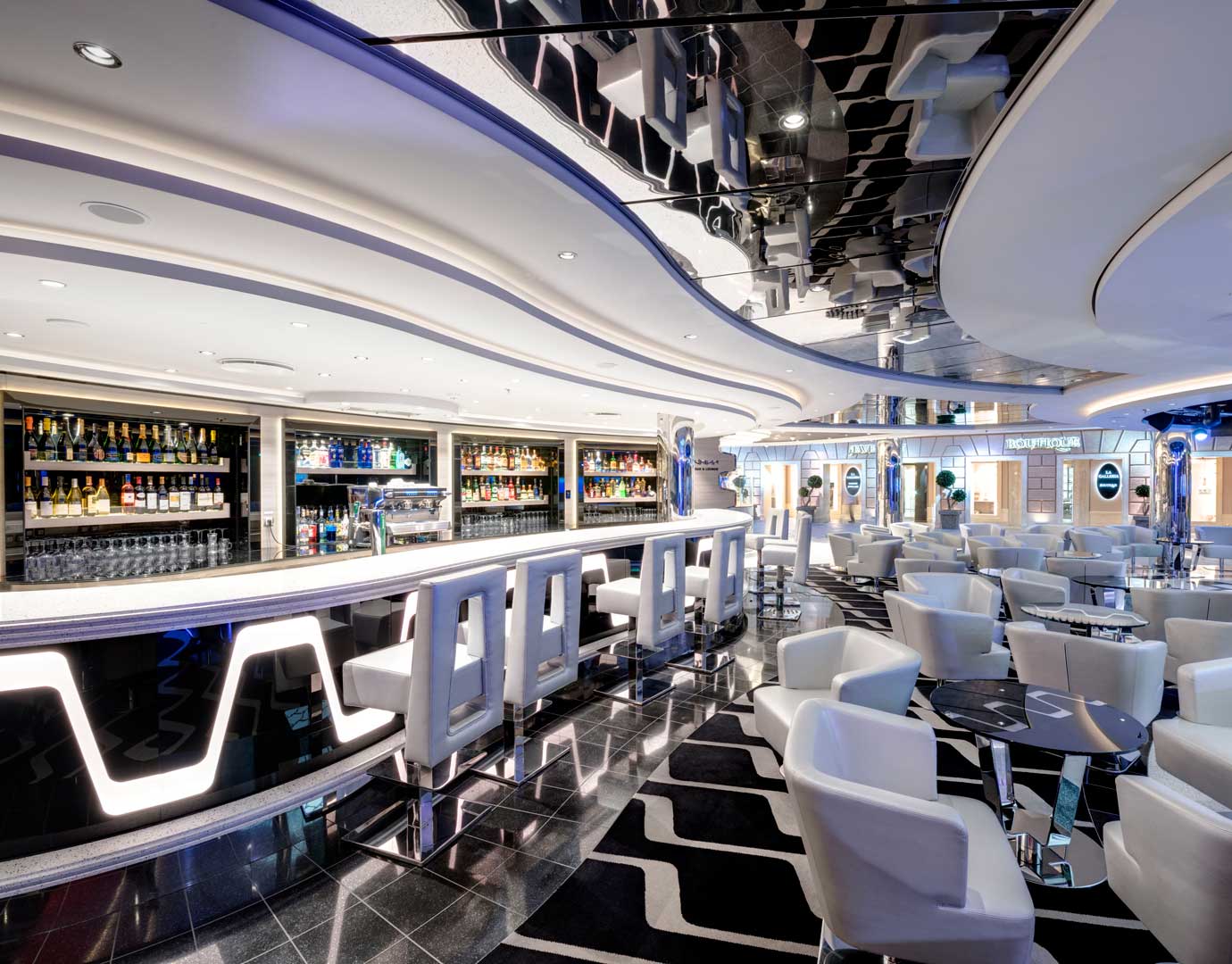 Modern onboard bar with illuminated counter, stylish seating, and a wide selection of drinks | MSC Cruises Modern onboard bar with illuminated counter, stylish seating, and a wide selection of drinks | MSC Cruises