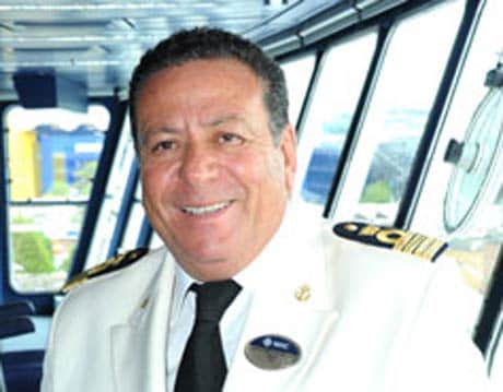A captain in a white uniform on the bridge of an MSC cruise ship | MSC Cruises A captain in a white uniform on the bridge of an MSC cruise ship | MSC Cruises